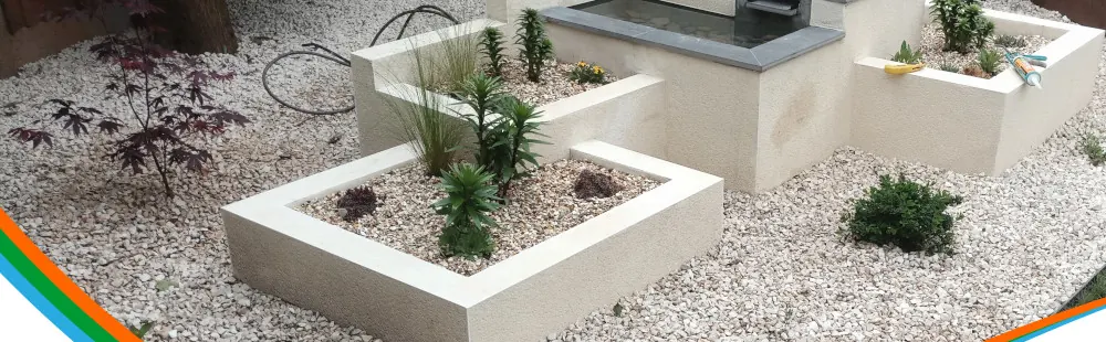 Rendered raised beds with gravel and planting