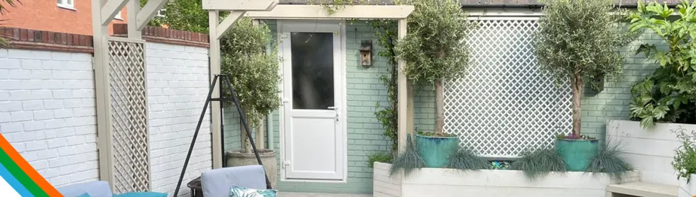 A newly built courtyard garden with seating, planting and a timber pergola